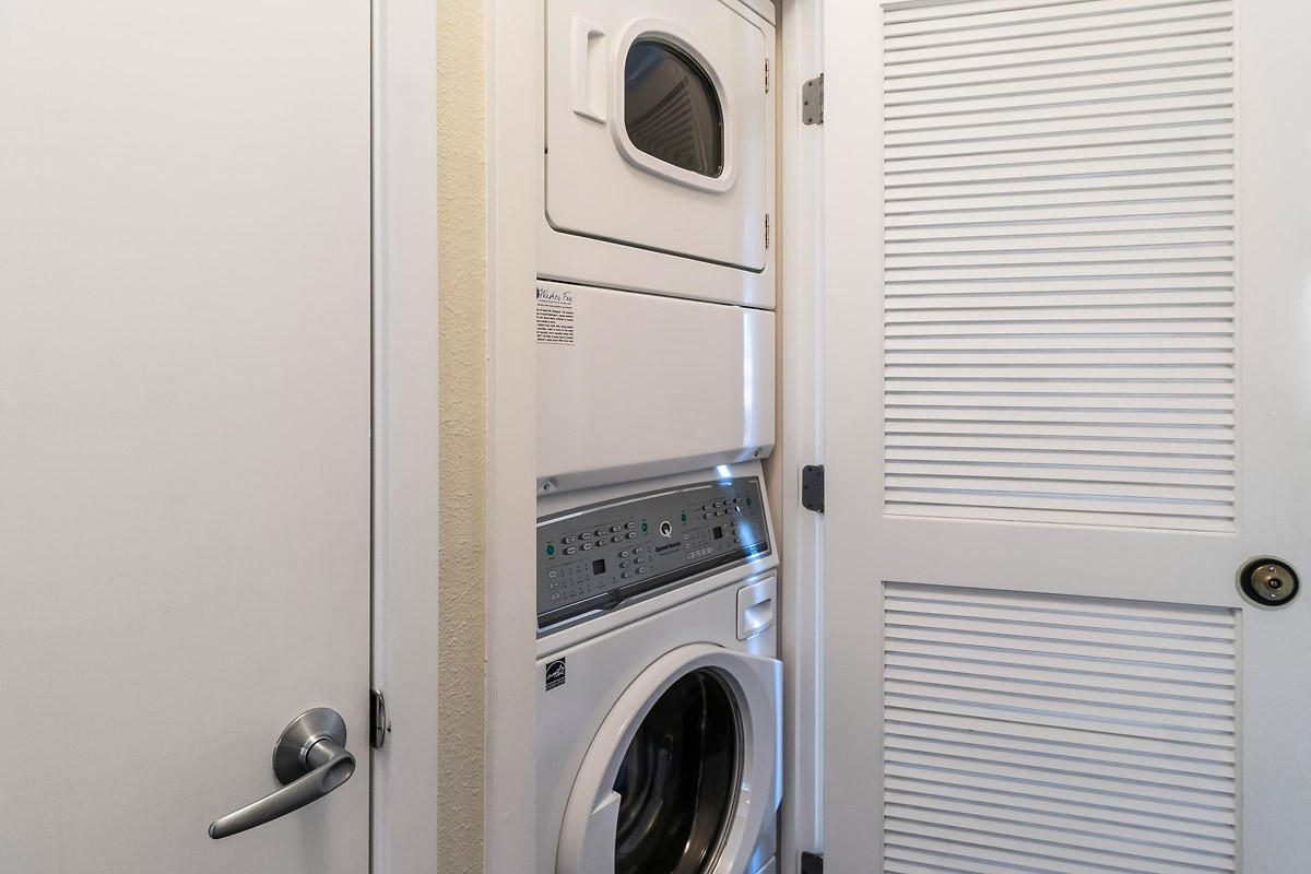 Full-size stack washer and dryer in hall closet