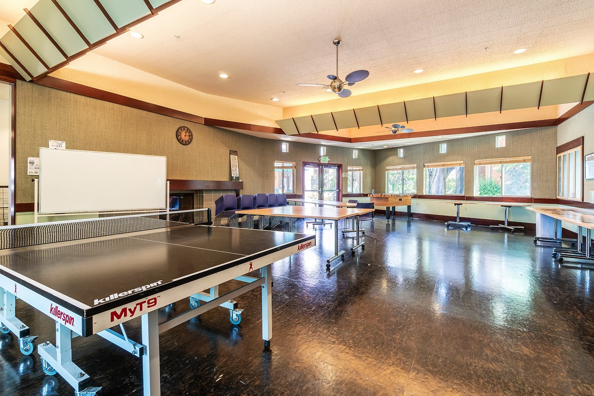 Ping pong and Foosball tables in large room of Common House